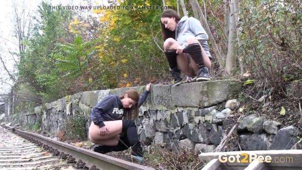Watch these kinky girls get soaked in pee while getting frisky on the railway - sexu.com on systemporn.com