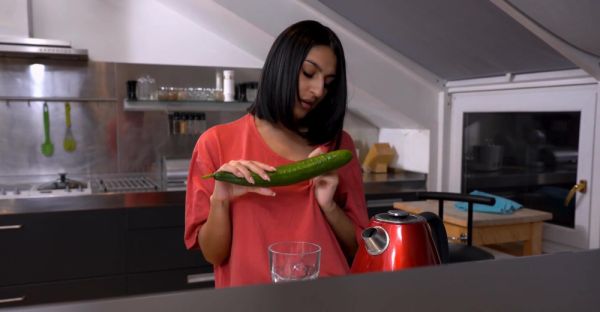 A cute girl peels a cucumber for her older man in a sensual scene. - alphaporno.com on systemporn.com